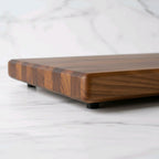 Wooden cutting board on a white marble surface