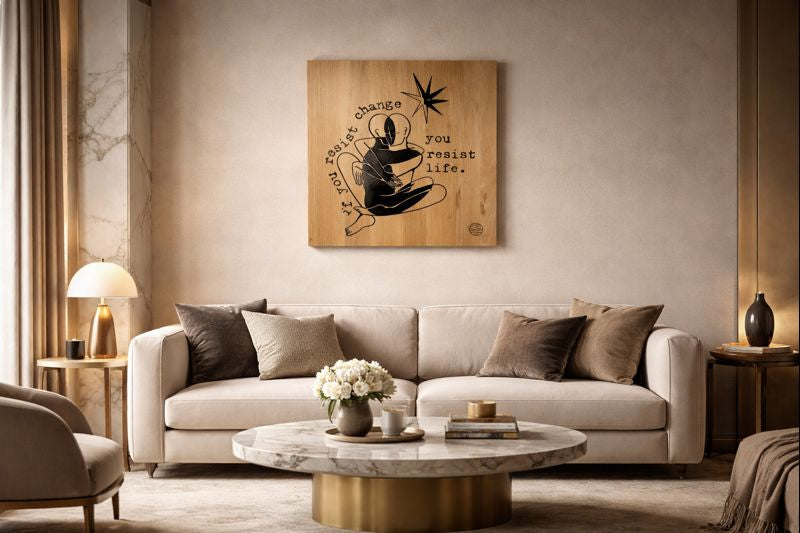 Modern living room with a beige sofa, marble coffee table, and decorative wall art.