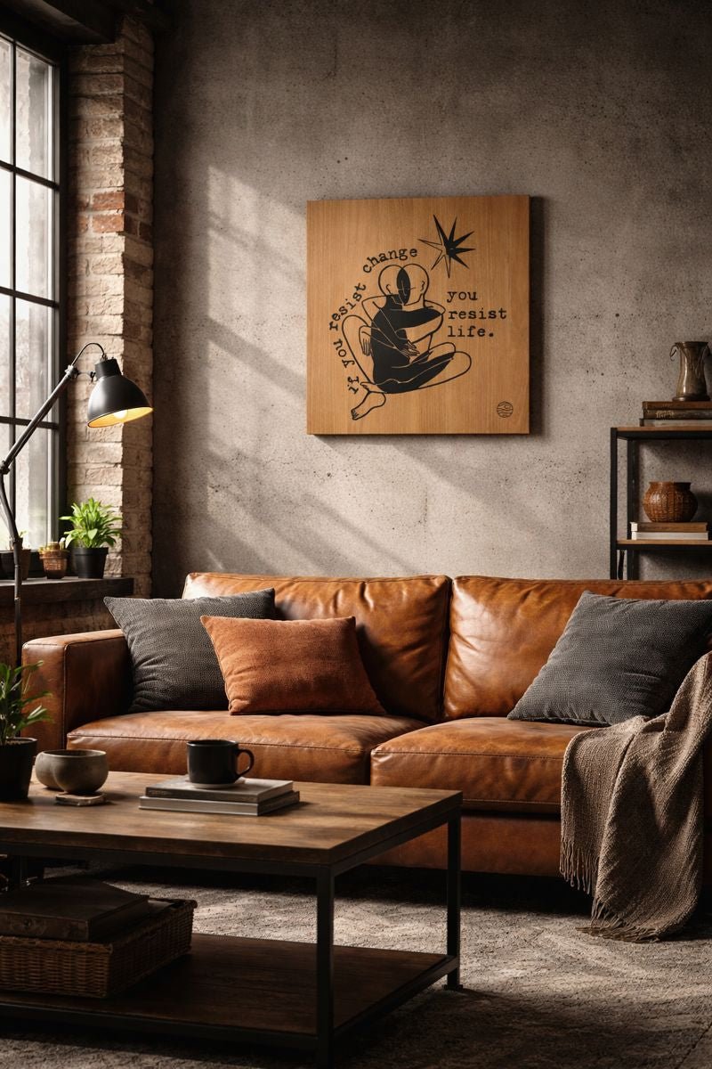 Cozy living room with brown leather sofa, wooden coffee table, and wall art.