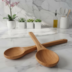 Two wooden measuring spoons with 'Woodiale' branding on a light background