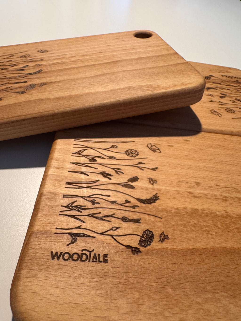 Wooden cutting boards with engraved designs on a light background