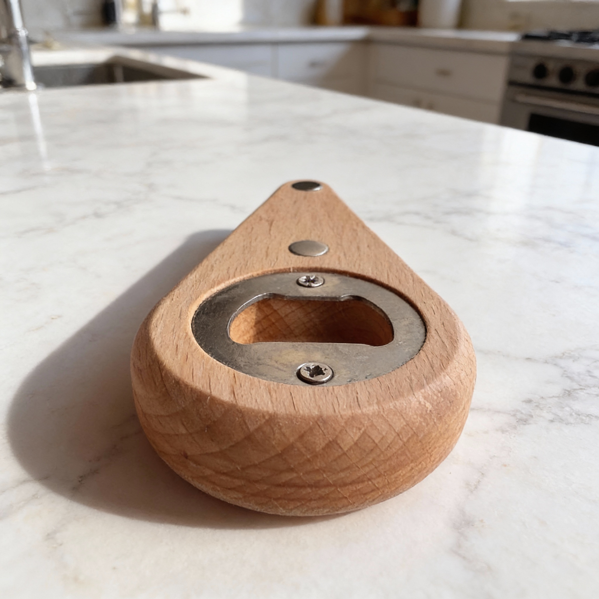 Wooden bottle opener on a marble kitchen counter