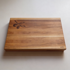 Wooden cutting board with olive design on a white background