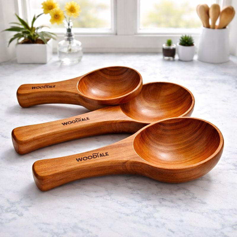 Set of three wooden spoons with 'Woodtale' branding on a marble surface.