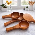 Set of wooden sauce&catering spoon on a marble surface with a kitchen background